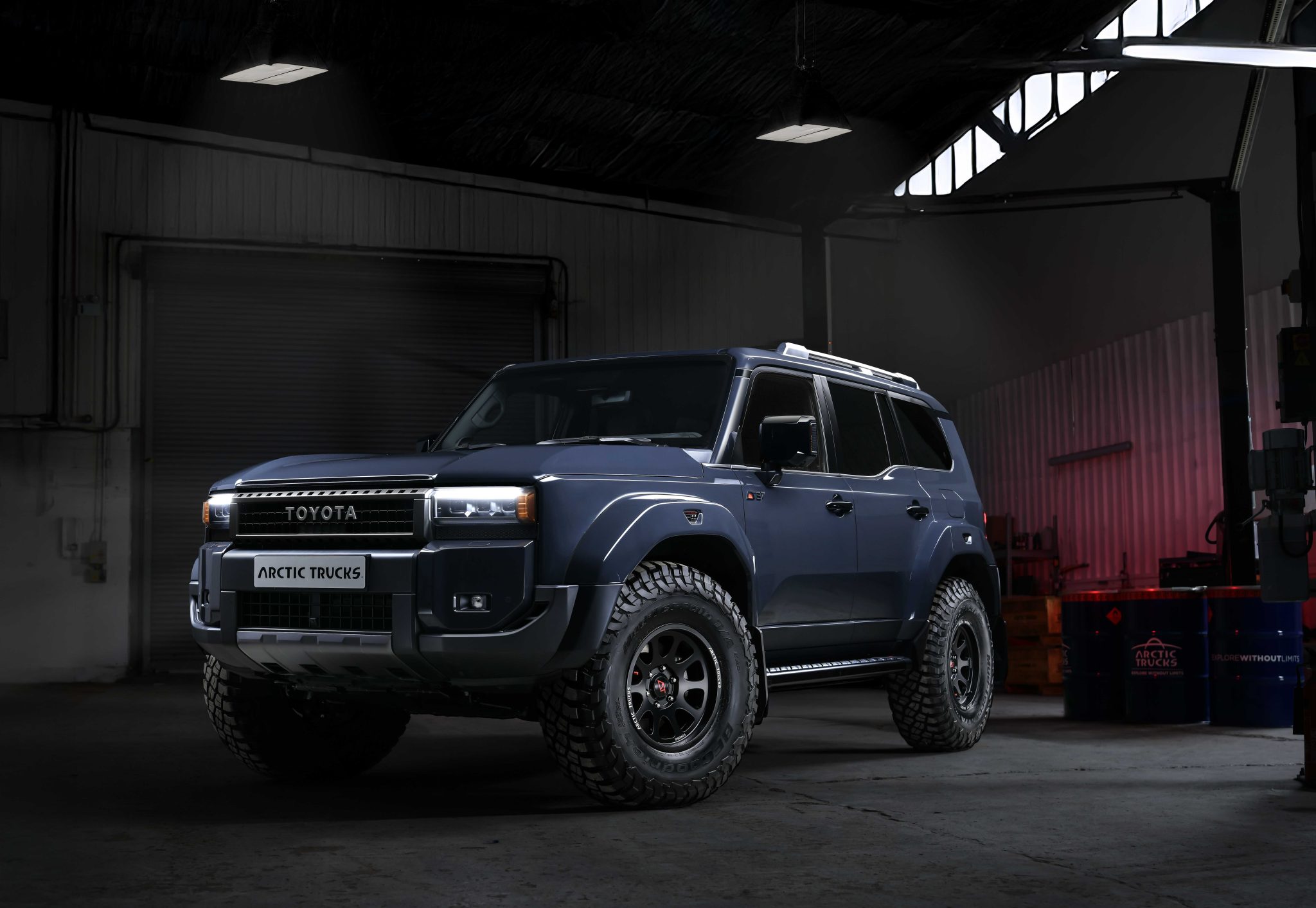 Dark garage with a rugged blue Toyota SUV, 